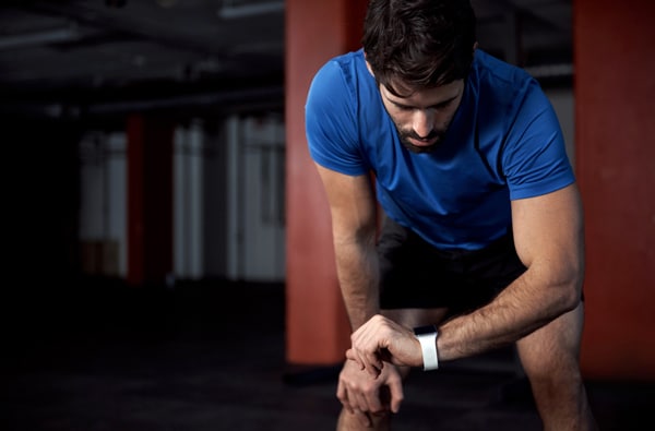 Man Looking at His Watch While Working Out